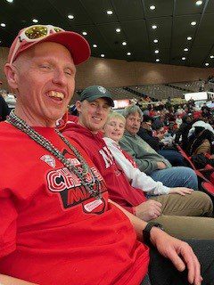 A man in a stadium smiling.